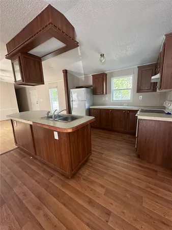 a kitchen with stainless steel appliances granite countertop a sink and a stove