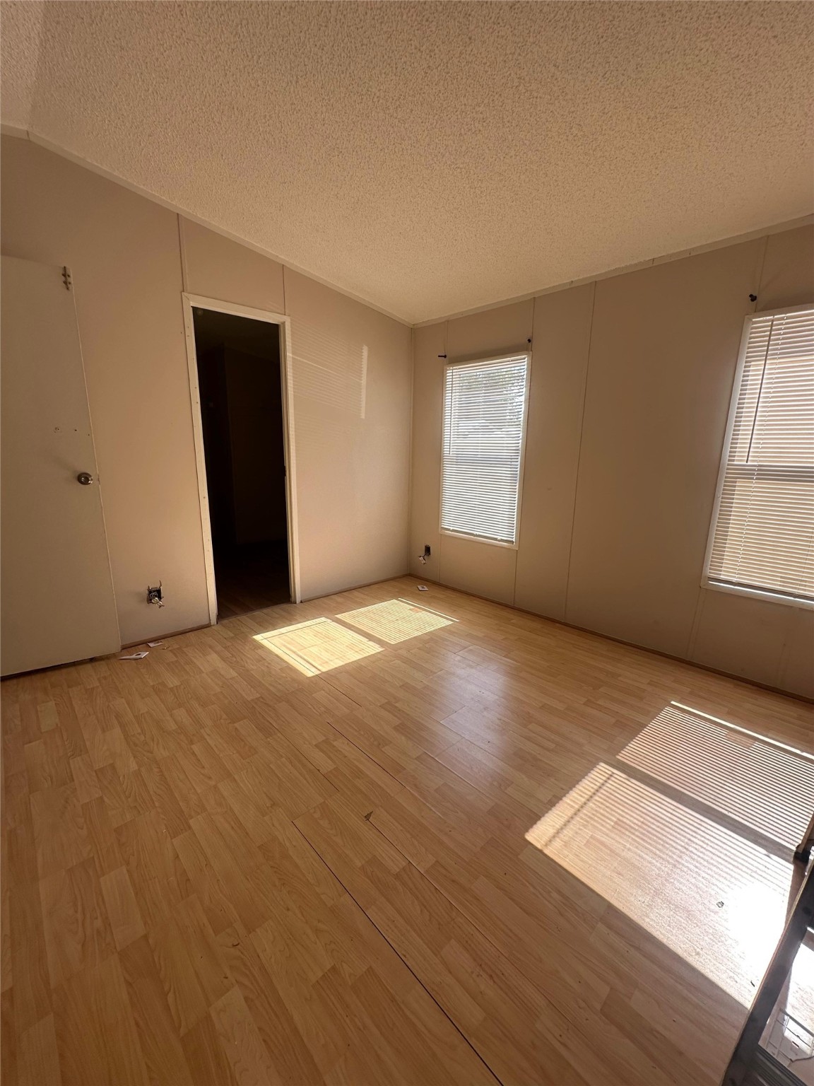 13521 Ann Louise Road Houston, TX 77086 - Photo 8 of 13 an empty room with wooden floor and windows