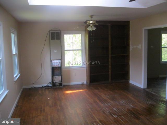 29070 Polks Road Princess Anne, MD 21853 - Photo 3 of 8 an empty room with wooden floor and windows