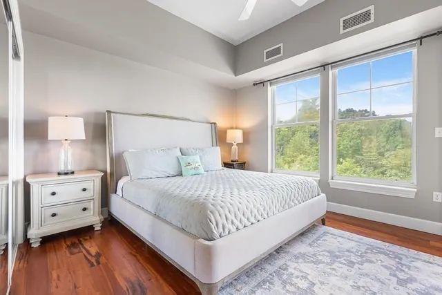 a bed sitting in a bedroom next to a window