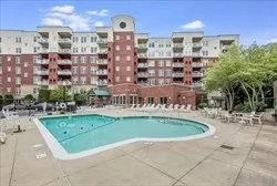 a view of swimming pool with outdoor seating and plants