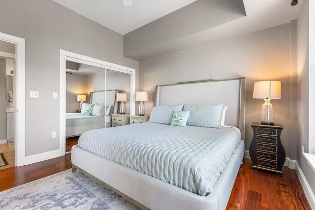 a bedroom with a bed and a mirror