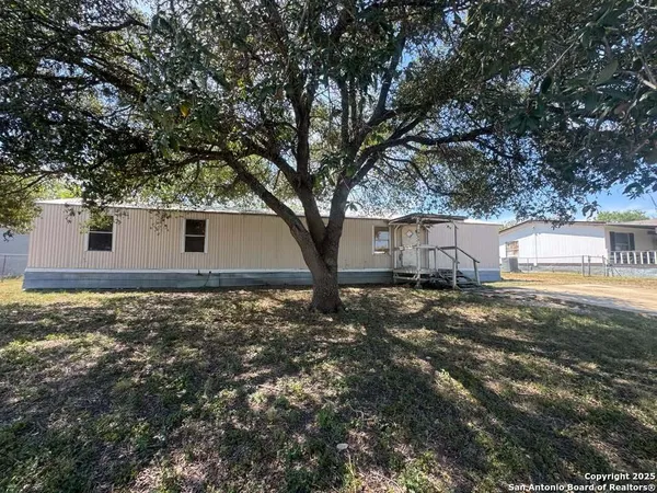 a view of a house with yard and tree s
