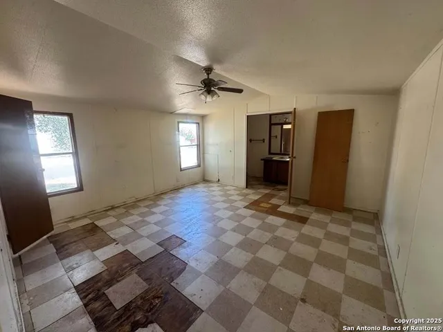 a kitchen with granite countertop a stove a sink and a refrigerator