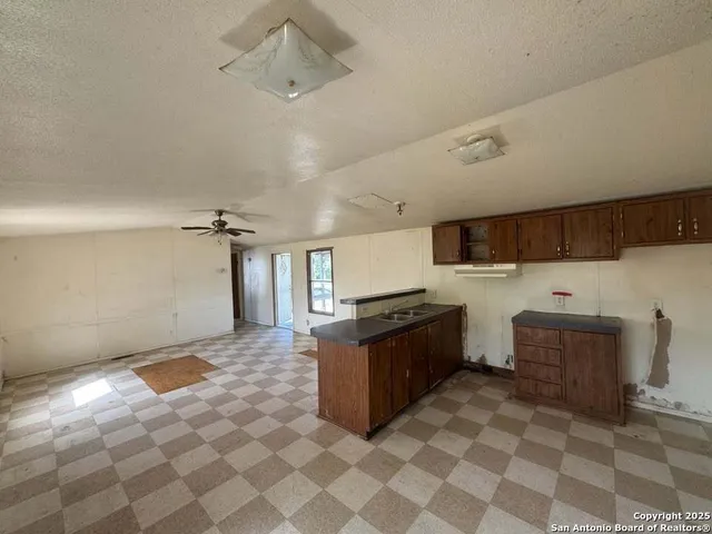a view of a field with trees in the background