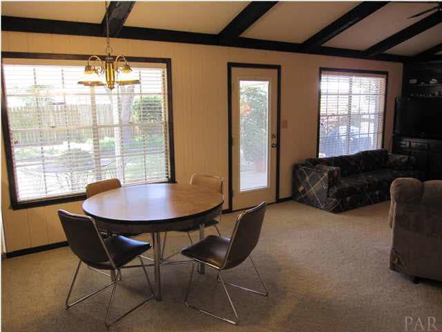 4265 April Road Pensacola, FL 32504 - Photo 9 of 25 View of the breakfast area. The breakfast bar & kitchen are to your left. The french door to the covered patio has built-in mini blinds.