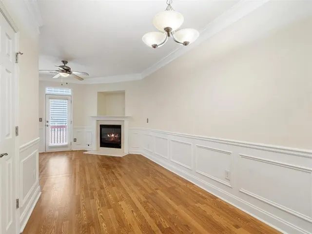 a view of an empty room with a fireplace and a window