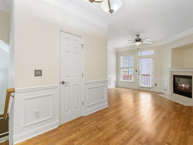 a view of empty room with wooden floor and fireplace