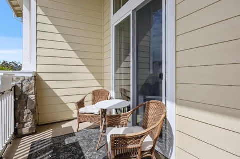 a view of balcony with chairs and table