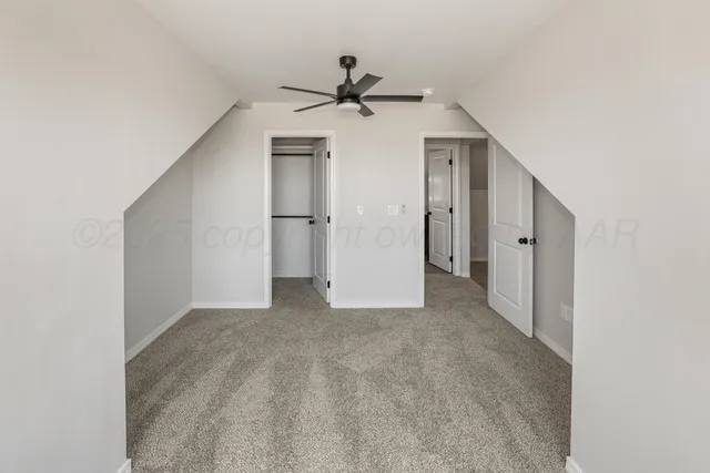 a view of a livingroom with a ceiling fan & entryway