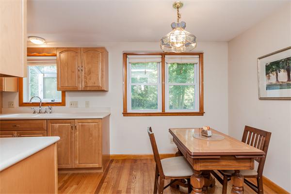 36 Blossom Road West Springfield, MA 01089 - Photo 14 of 30 a dining room with wooden floor a chandelier a wooden table and chairs