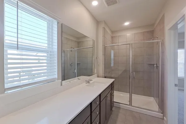 a bathroom with a shower and a sink