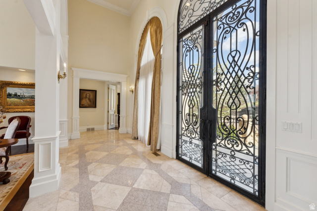 1714 Ridge Point Drive Bountiful, UT 84010 - Photo 17 of 132 Two-story entry with patterned tile flooring, wrought iron double doors, and architectural columns