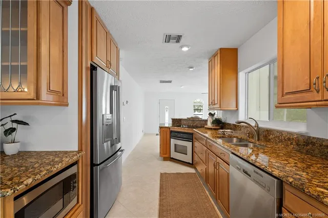 a kitchen with granite countertop a stove and a sink