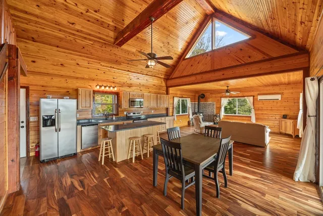 a dining room with furniture and wooden floor