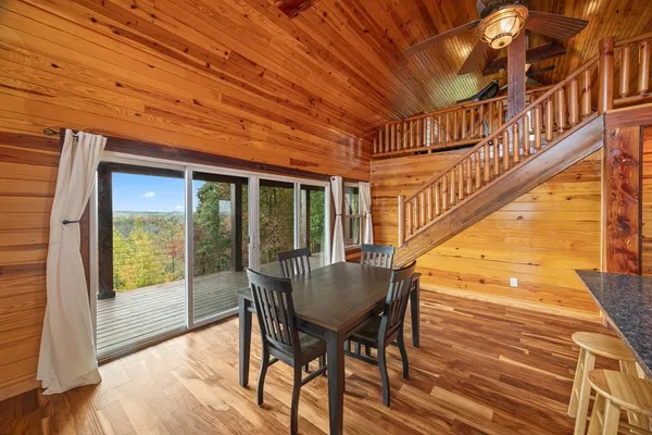 a dining room with furniture and wooden floor