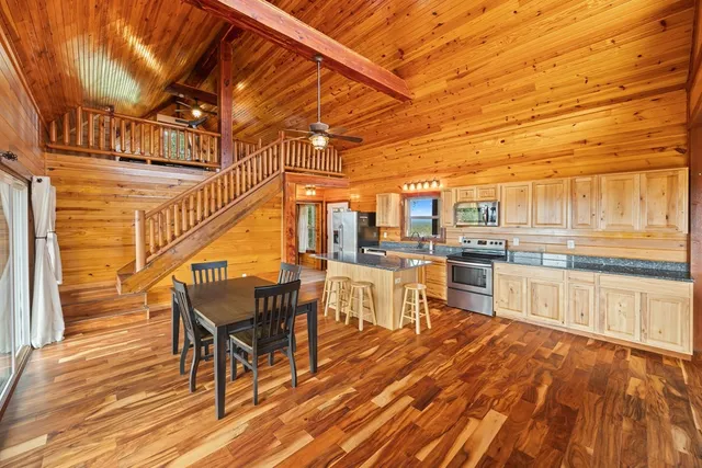 a outdoor space with lots of wooden furniture and appliances