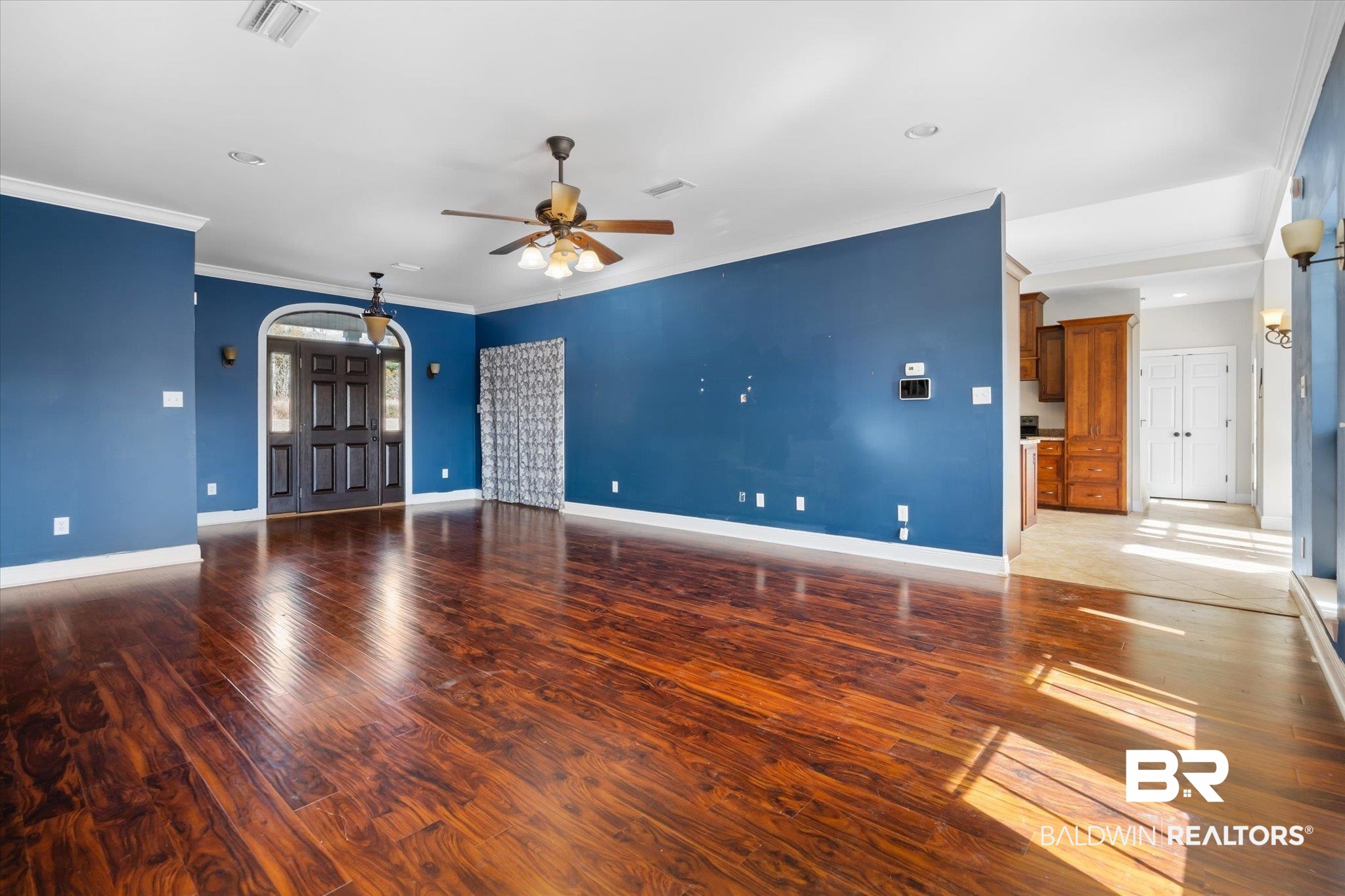 20792 Lonnie Walker Road Citronelle, AL 36522 - Photo 4 of 19 Unfurnished living room featuring ornamental molding, hardwood / wood-style floors, and ceiling fan