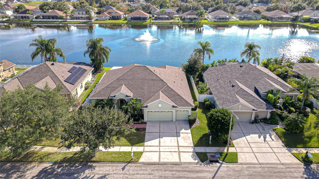 a aerial view of a house with garden space and lake view