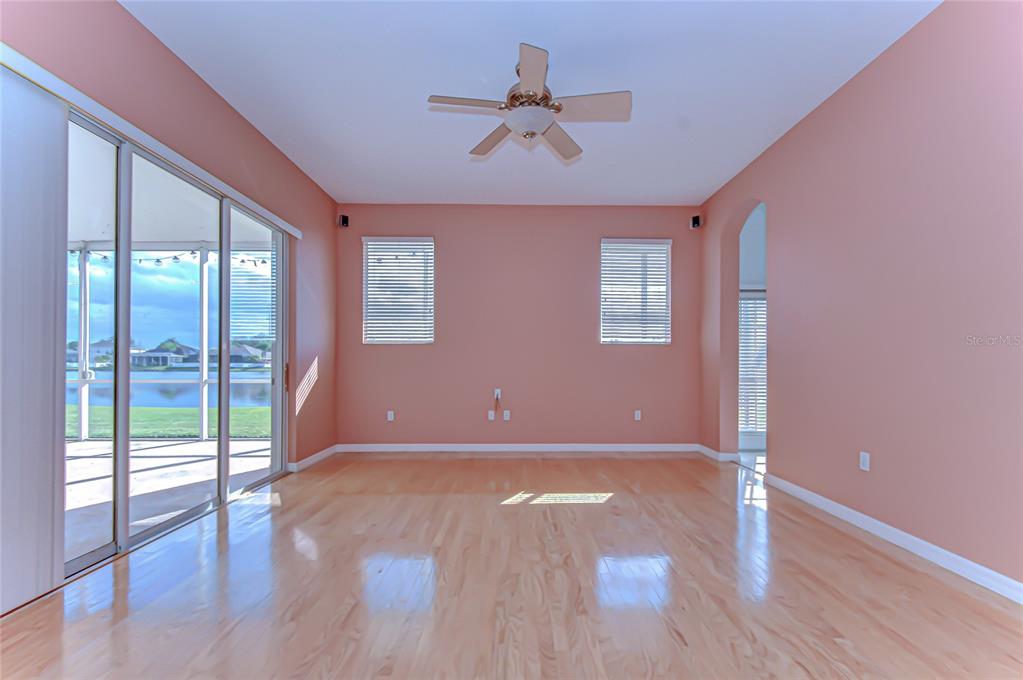 22704 Cliffside Way Land O' Lakes, FL 34639 - Photo 14 of 33 an empty room with wooden floor and windows