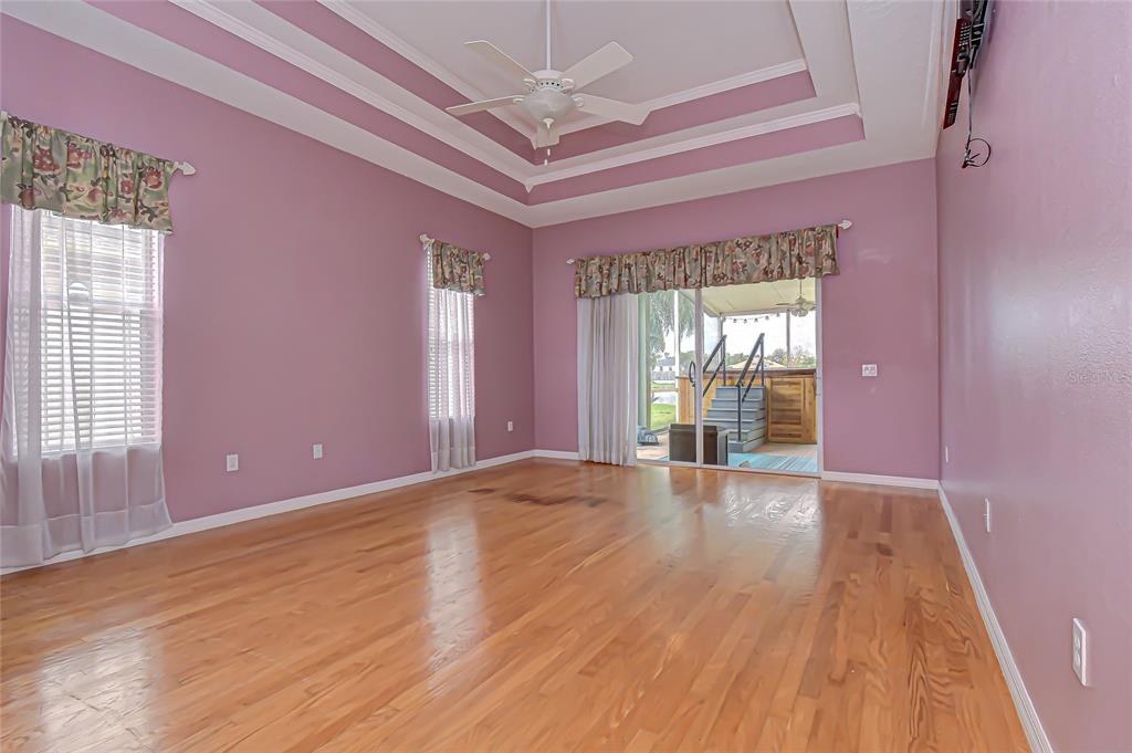 22704 Cliffside Way Land O' Lakes, FL 34639 - Photo 15 of 33 a view of an empty room with wooden floor and a window