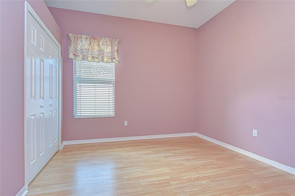 22704 Cliffside Way Land O' Lakes, FL 34639 - Photo 17 of 33 a view of empty room with wooden floor and fan