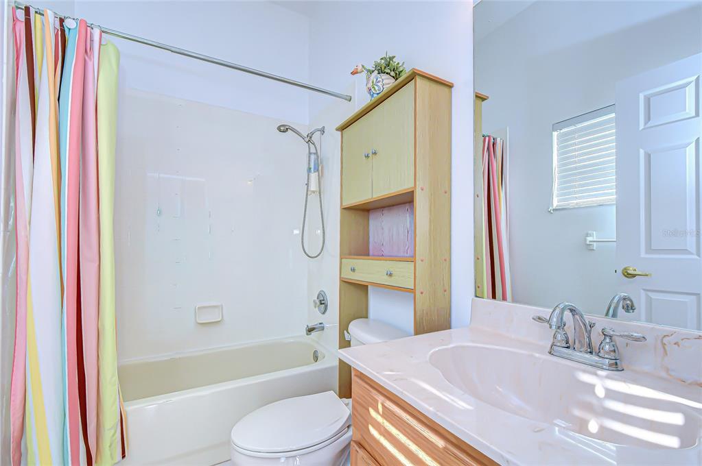 22704 Cliffside Way Land O' Lakes, FL 34639 - Photo 20 of 33 a bathroom with a granite countertop sink and a mirror