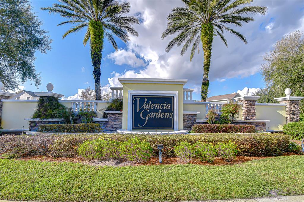 22704 Cliffside Way Land O' Lakes, FL 34639 - Photo 4 of 33 a front view of a house with a garden and swimming pool