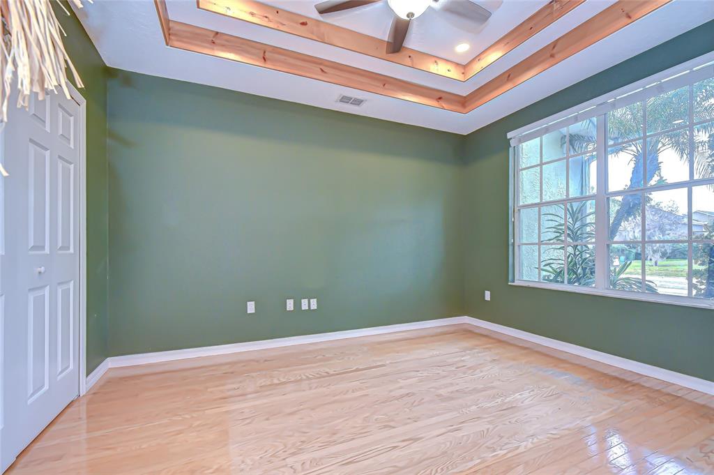 22704 Cliffside Way Land O' Lakes, FL 34639 - Photo 8 of 33 an empty room with wooden floor and windows