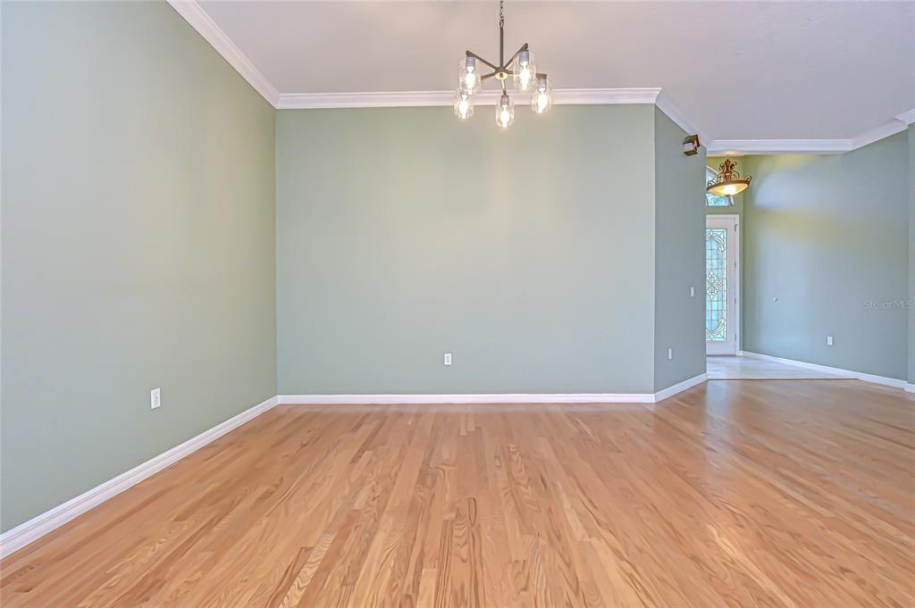 22704 Cliffside Way Land O' Lakes, FL 34639 - Photo 10 of 33 a view of an empty room with wooden floor