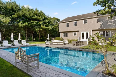 a view of a swimming pool with chairs