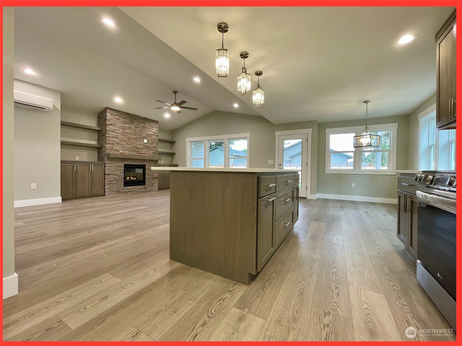 154 Seagate Street Southwest Ocean Shores, WA 98569 - Photo 16 of 36 a large kitchen with kitchen island a stove a sink dishwasher and a oven with wooden floor