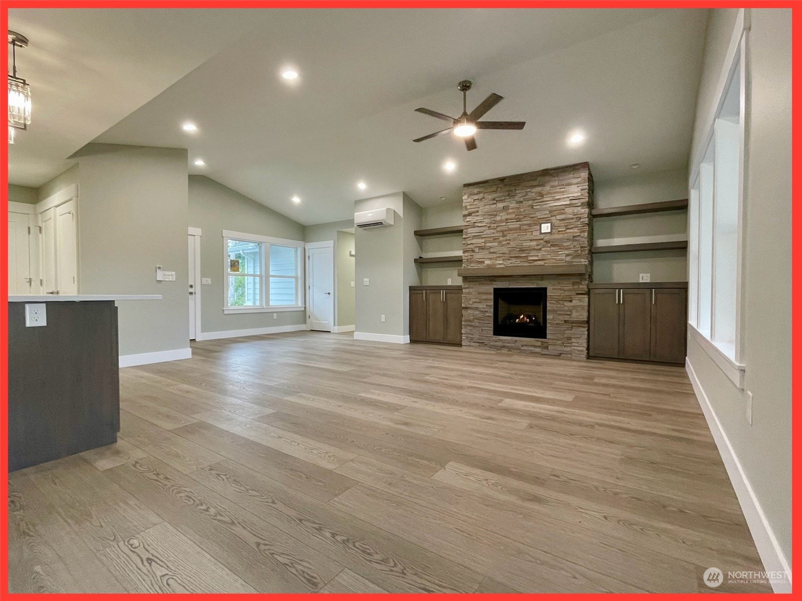 154 Seagate Street Southwest Ocean Shores, WA 98569 - Photo 21 of 36 an empty room with kitchen and fireplace