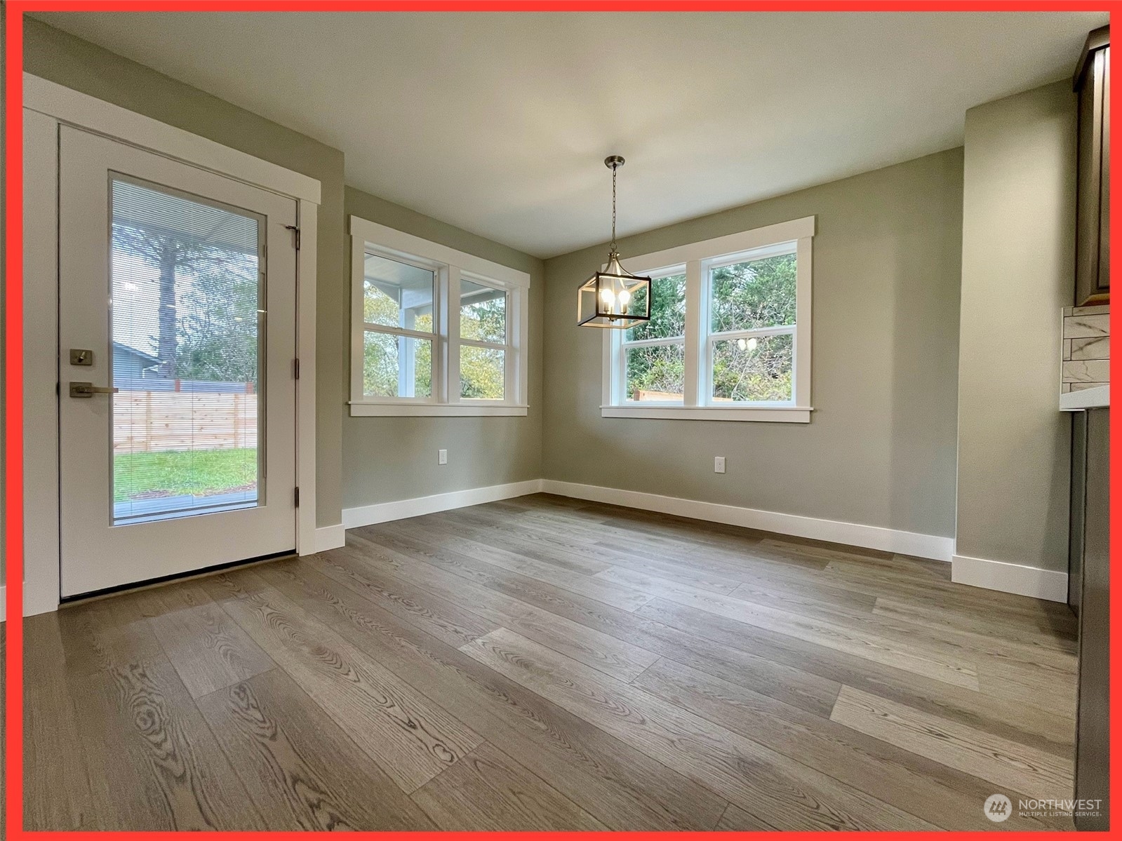 154 Seagate Street Southwest Ocean Shores, WA 98569 - Photo 24 of 36 an empty room with wooden floor and windows