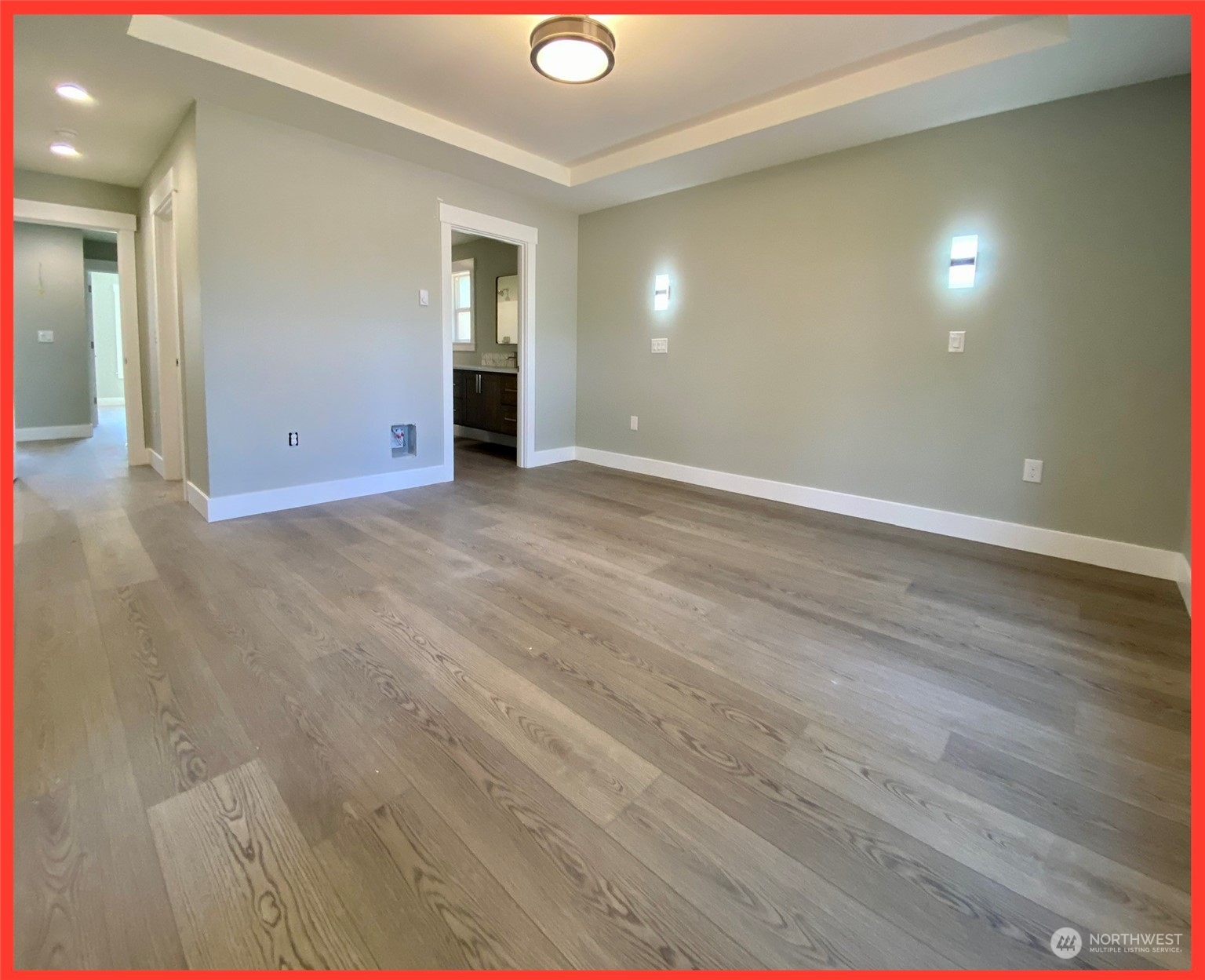 154 Seagate Street Southwest Ocean Shores, WA 98569 - Photo 27 of 36 an empty room with wooden floor and windows