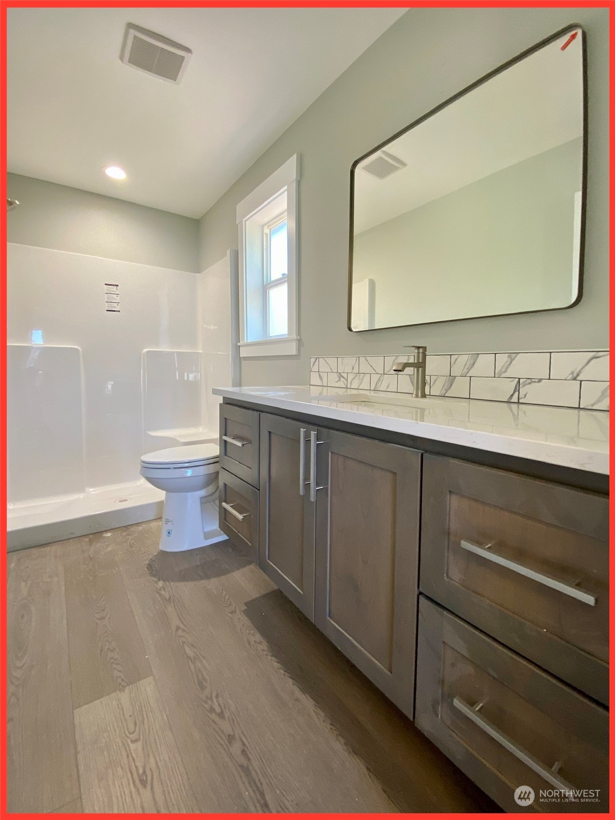 154 Seagate Street Southwest Ocean Shores, WA 98569 - Photo 28 of 36 a bathroom with a toilet sink and mirror