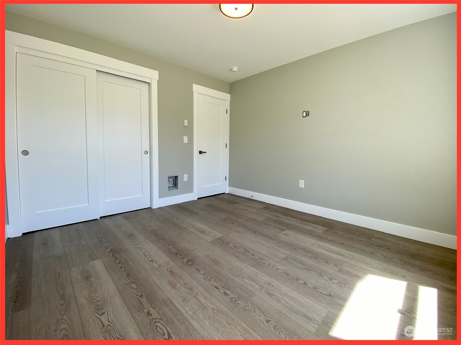 154 Seagate Street Southwest Ocean Shores, WA 98569 - Photo 32 of 36 a view of an empty room with wooden floor
