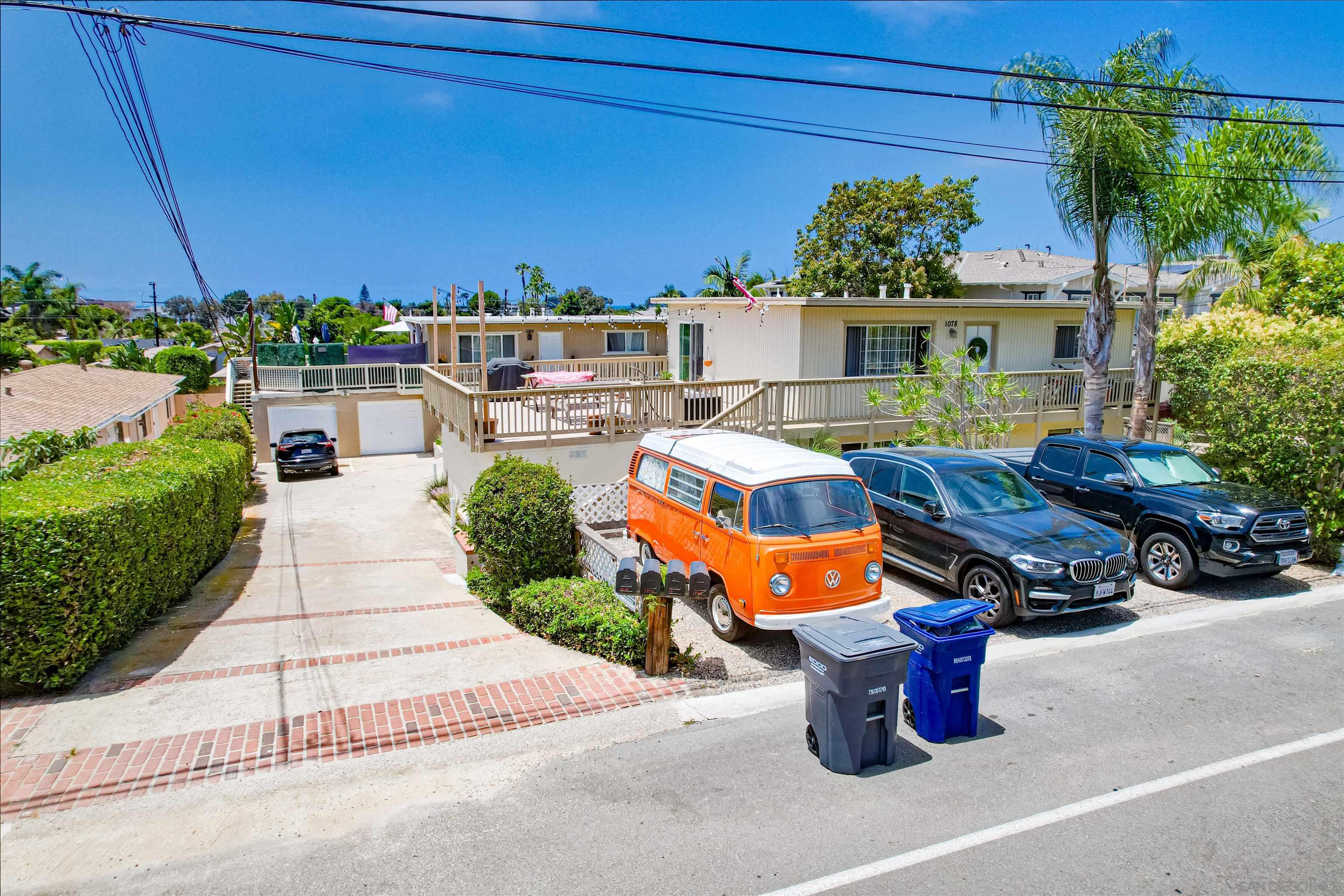 1076 Gardena Road Encinitas, CA 92024 - Photo 2 of 9 a view of a patio with couches table and chairs under an umbrella