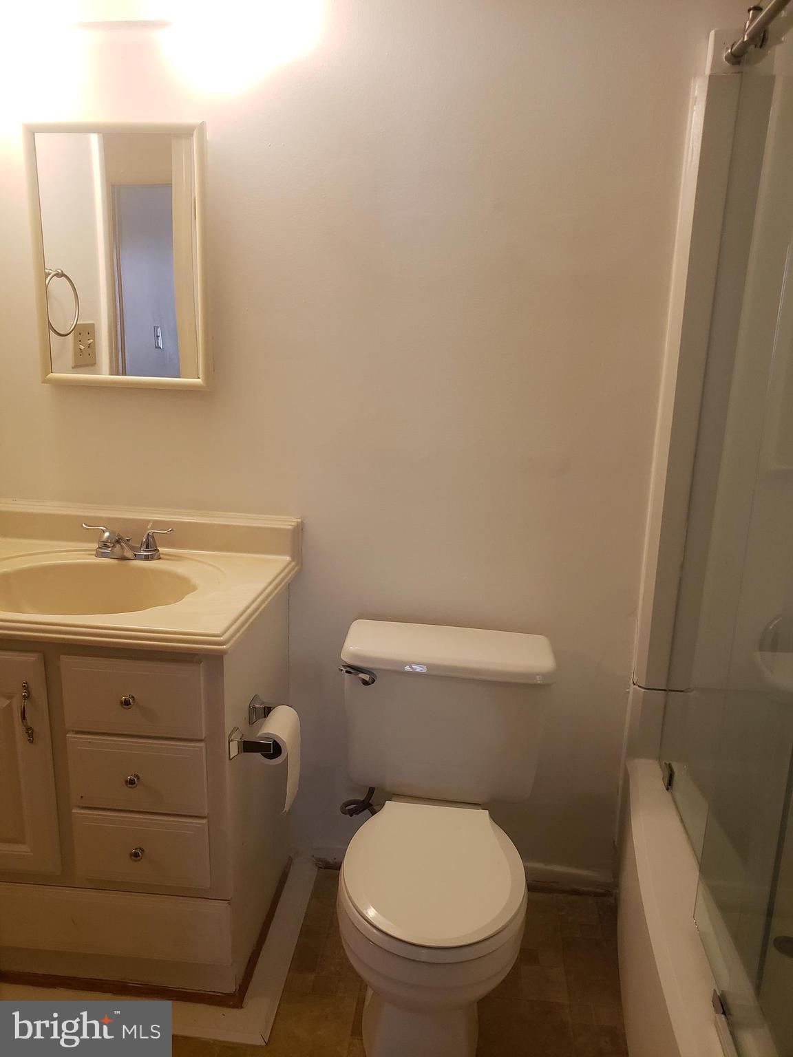 14582 Farmcrest Place Silver Spring, MD 20905 - Photo 11 of 19 a bathroom with a toilet sink and mirror