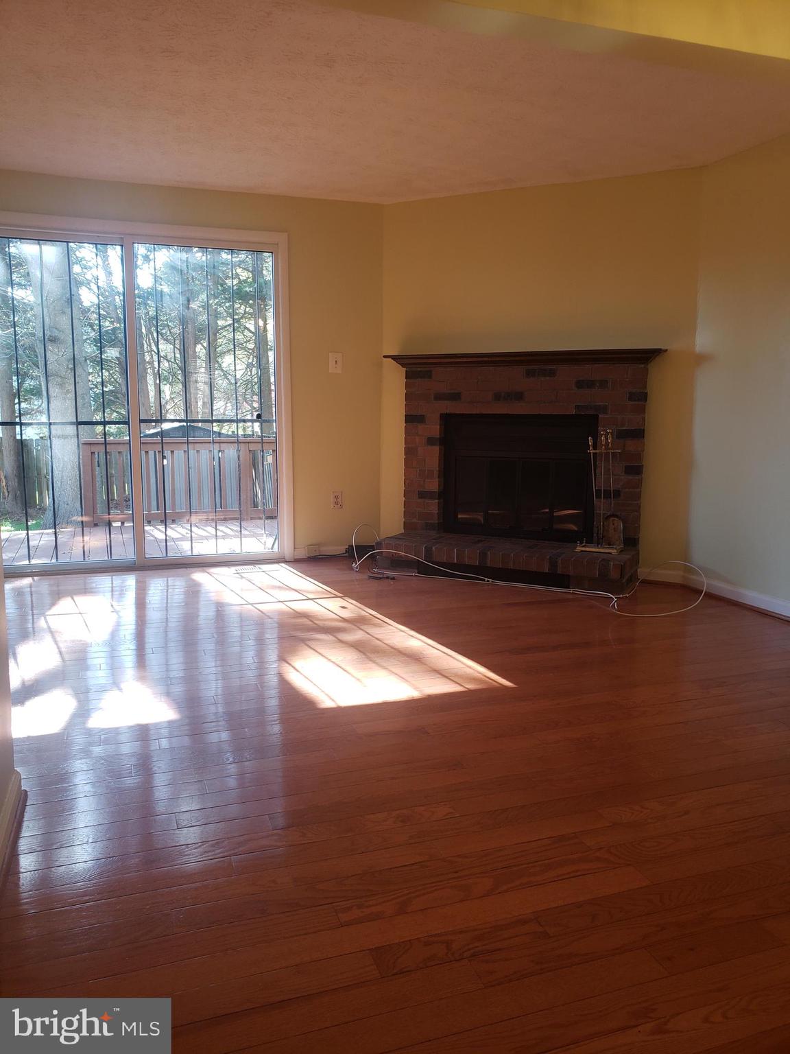 14582 Farmcrest Place Silver Spring, MD 20905 - Photo 4 of 19 a view of empty room with wooden floor and fireplace