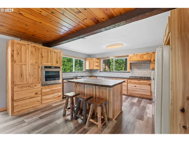 a kitchen with a stove a sink and a microwave