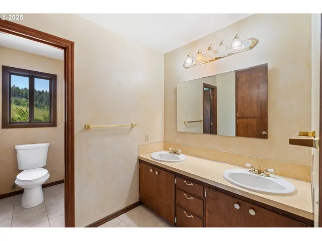 a room with pool table and windows