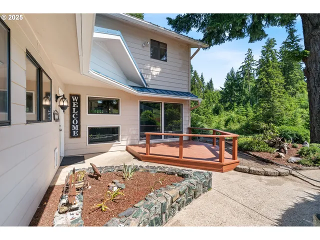 a view of a house with backyard and sitting area