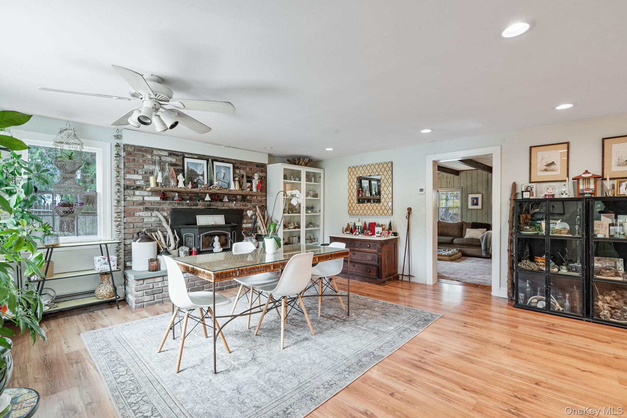 170 North Country Road Miller Place, NY 11764 - Photo 13 of 48 a dining room with wooden floor and chandelier