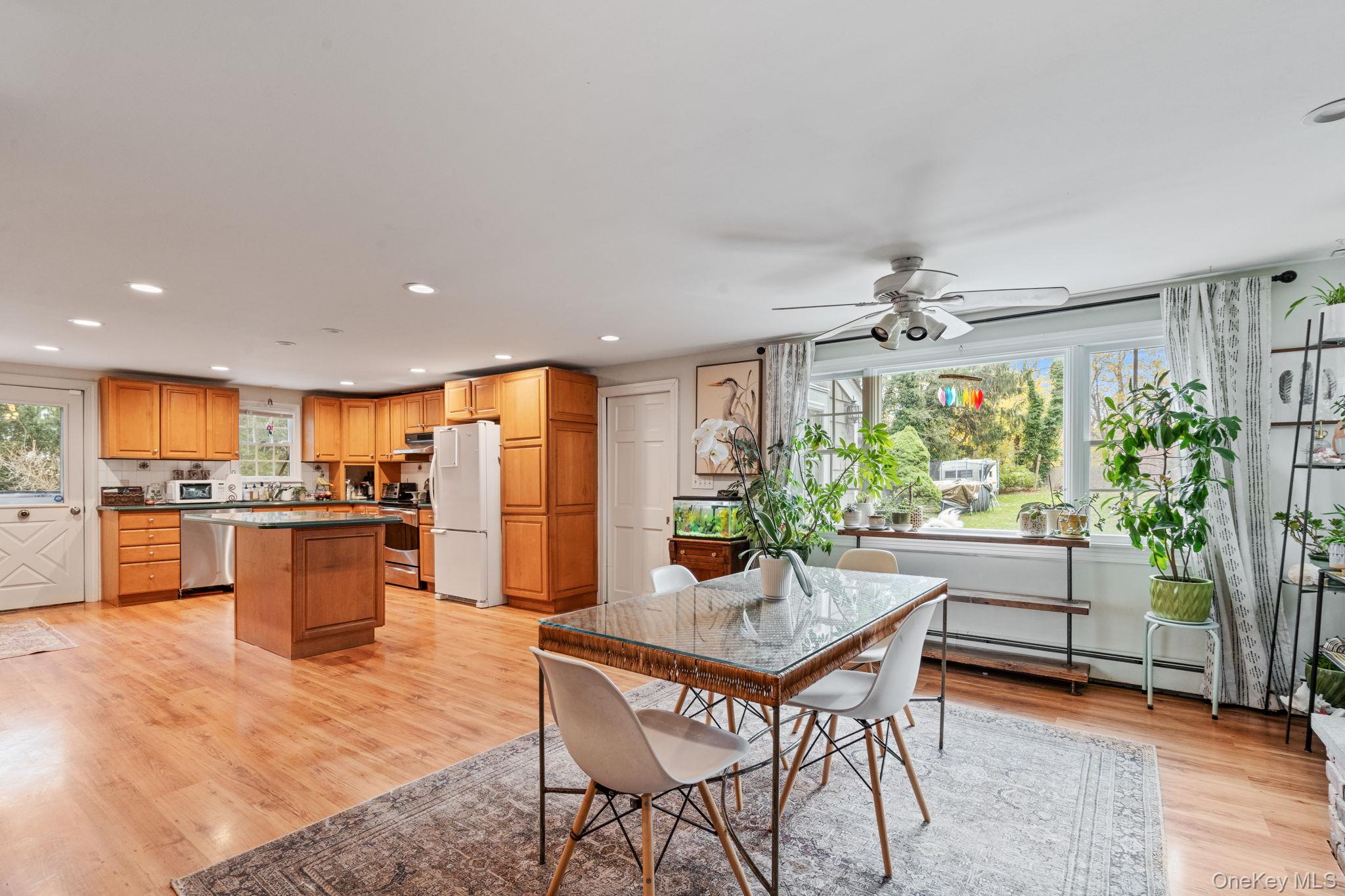 170 North Country Road Miller Place, NY 11764 - Photo 14 of 48 a kitchen with a table and chairs in it