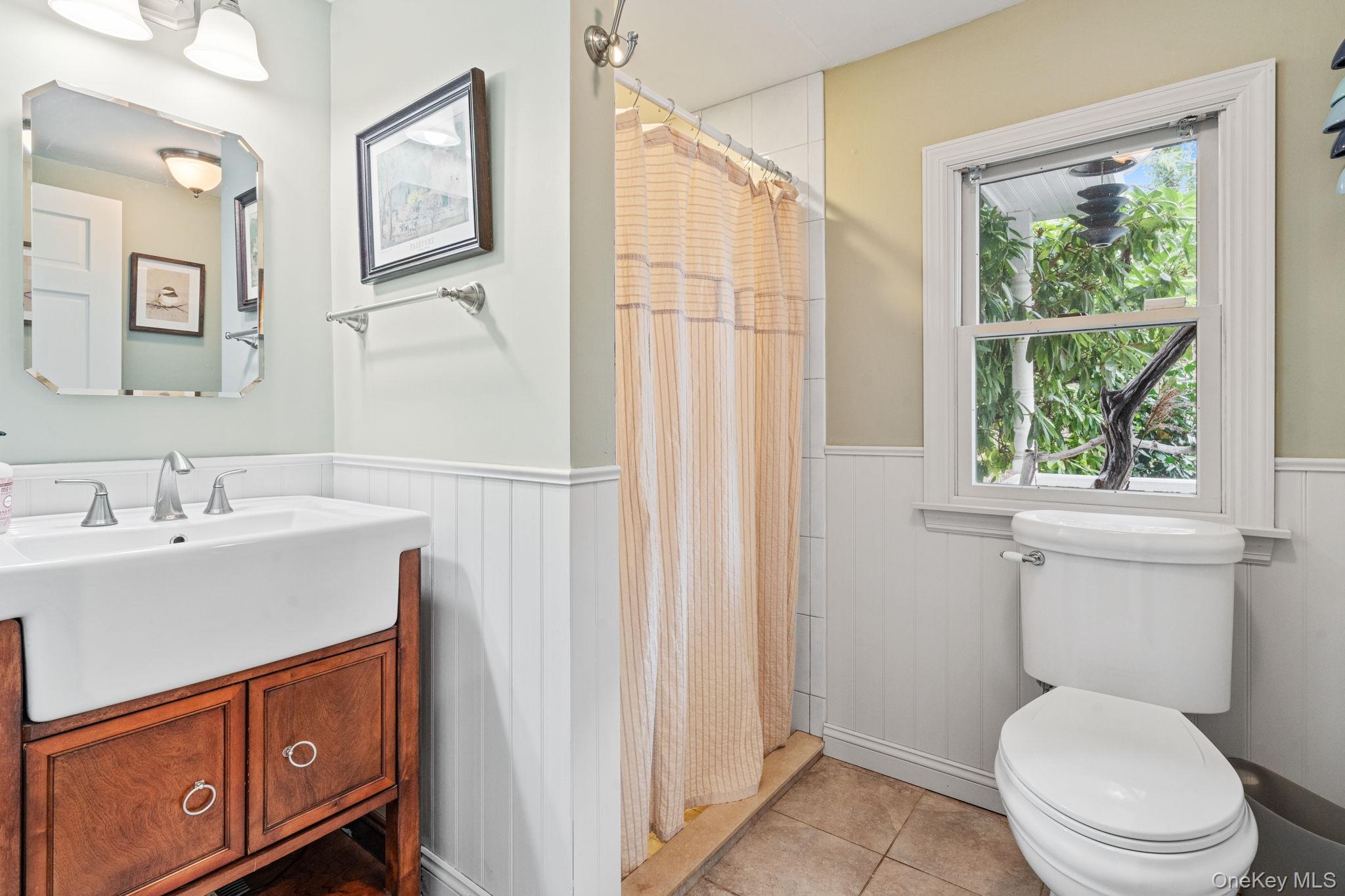 170 North Country Road Miller Place, NY 11764 - Photo 22 of 48 a white toilet sitting next to a bathroom sink