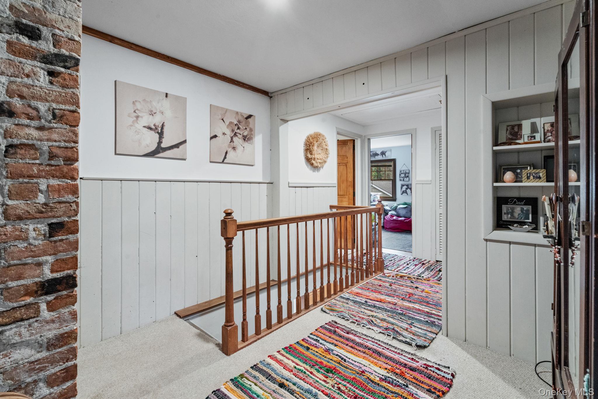 170 North Country Road Miller Place, NY 11764 - Photo 32 of 48 a view of a hallway with wooden floor and a bathroom