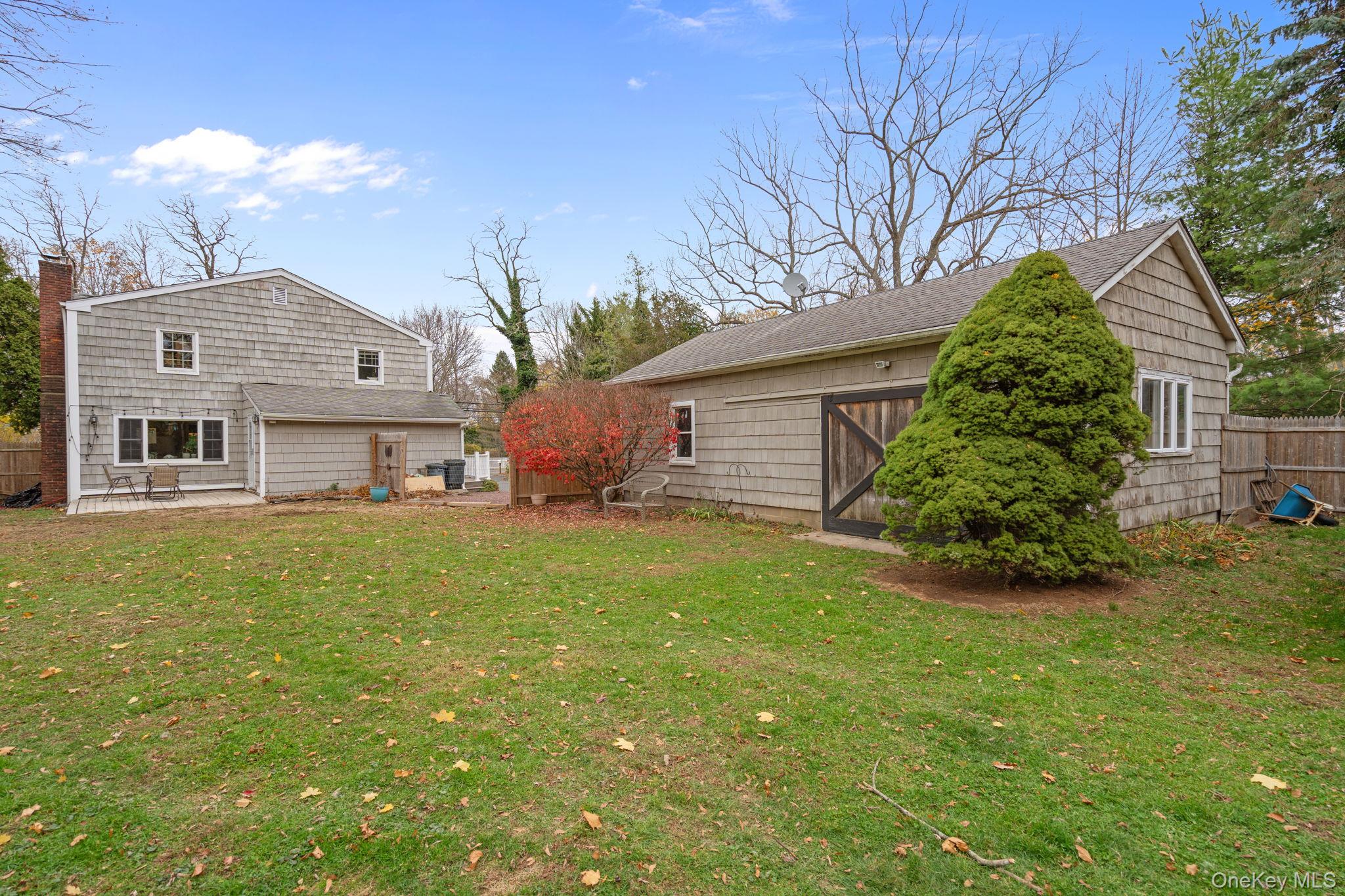 170 North Country Road Miller Place, NY 11764 - Photo 41 of 48 a front view of a house with garden