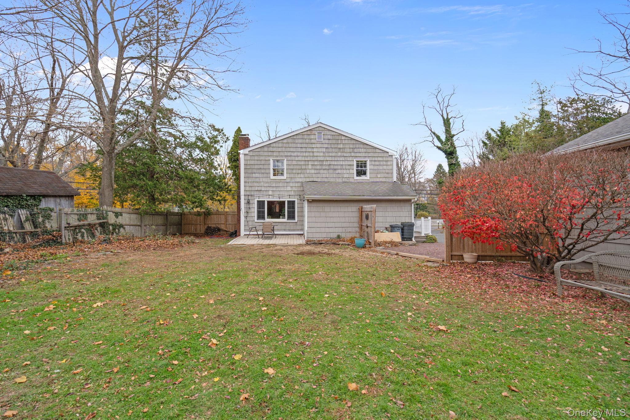 170 North Country Road Miller Place, NY 11764 - Photo 43 of 48 a front view of a house with a garden and trees