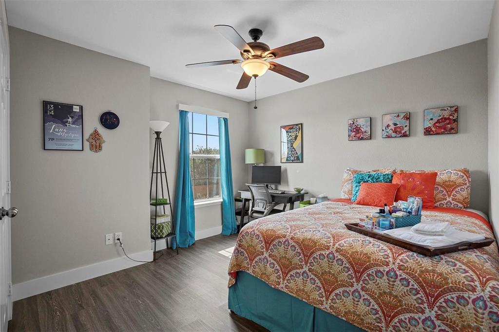 5113 Mountain Spring Trail Fort Worth, TX 76123 - Photo 22 of 35 a bedroom with a bed and a chandelier